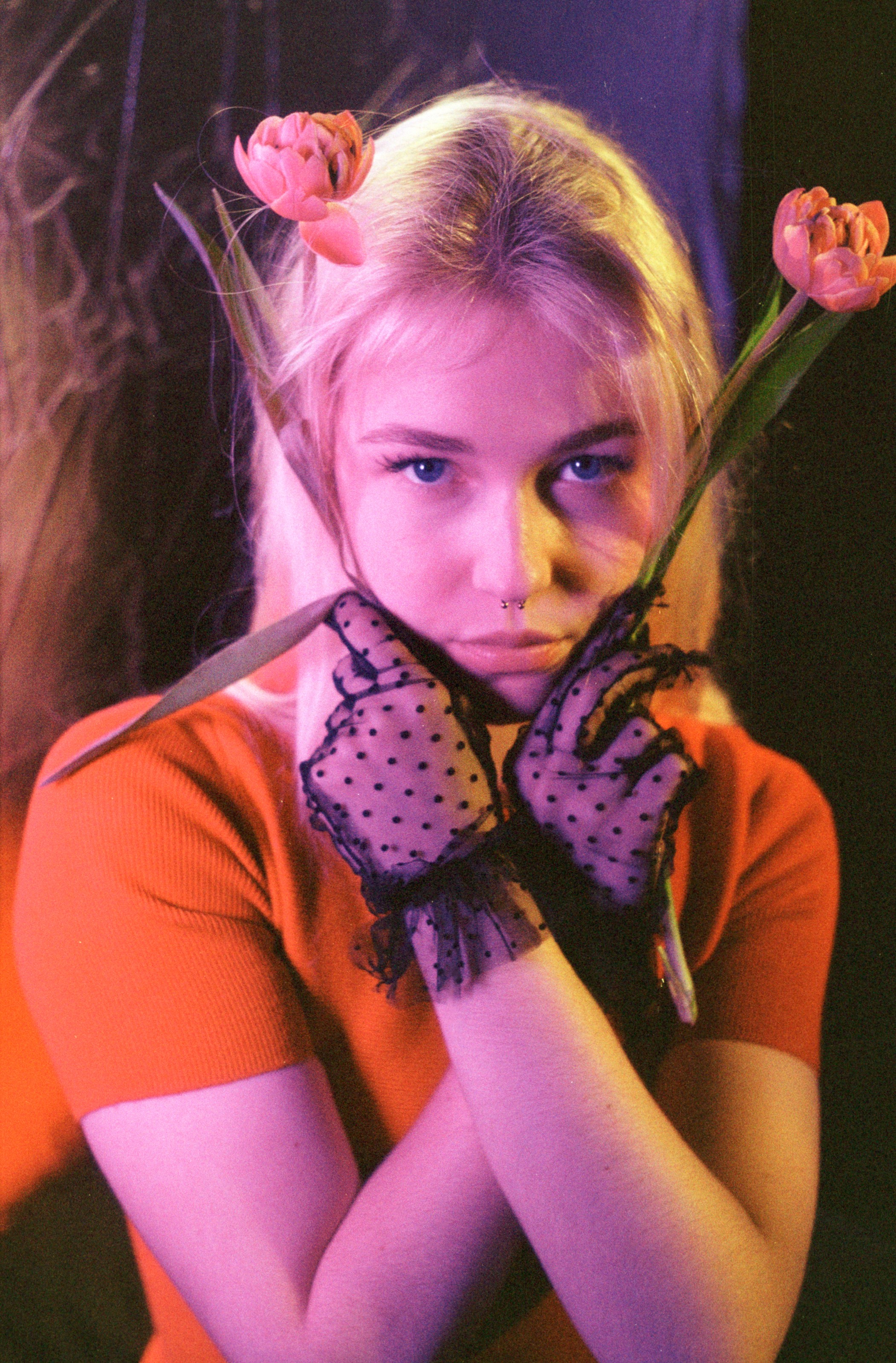 Double-exposure film portrait of Maria with tulips, in lace gloves